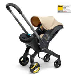 Doona I Babyskydd Och Barnvagn I Ett Sahara Sand